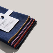 Atelier Saucier | Rainbow Denim Napkins, Set of 4, featuring colored edges in mustard, lavender, red, and navy. Crafted from reclaimed materials in Los Angeles.