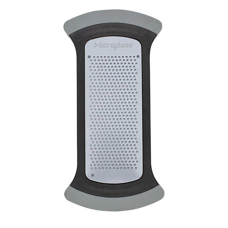 Microplane | Bowl Graters, Fine: A slim, handheld kitchen grater with a serrated stainless-steel surface, designed for efficient zesting and grating over mixing bowls.