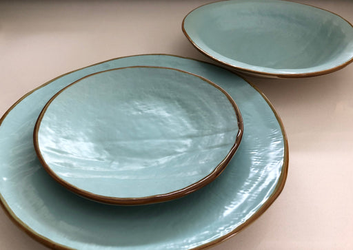 Close-up of Novita | Mediterranean Stoneware Dinner Plates - Gray, showcasing unique hand-dipped stoneware design with varied shapes and finishes, perfect for mix-and-match table settings.