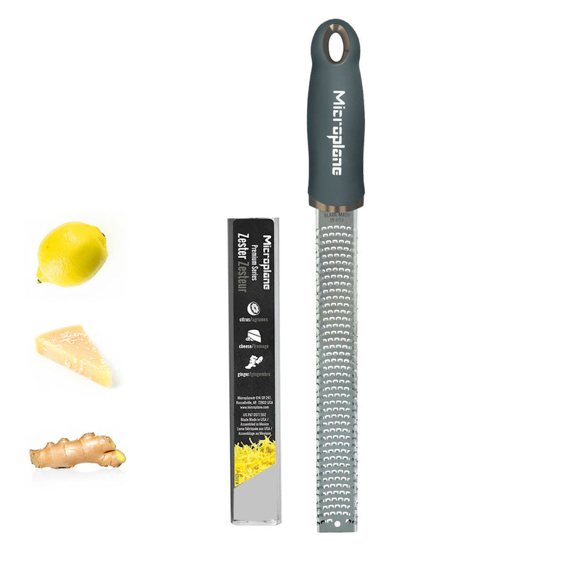 Microplane Premium Zester Grater - After Dark Grey, shown with lemon, cheese, and ginger, featuring stainless steel blades and soft-touch handle for versatile kitchen use.