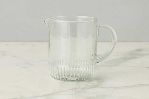 Etú HOME | Bistro Mini Jug on a marble surface, showcasing its elegant design with a graceful pour spout and sturdy handle, inspired by 1930s Depression glass.