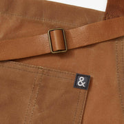 Hedley & Bennett | Essential Waxed Canvas Aprons - Montana: A durable apron with an adjustable leather neck strap, navy waist tie, utility loop, and multiple pockets. Ideal for kitchen or DIY tasks.