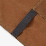 Hedley & Bennett | Essential Waxed Canvas Aprons - Montana: Durable, waxed canvas apron with adjustable leather neck strap, navy waist tie, utility loop, and multiple pockets for versatile use.