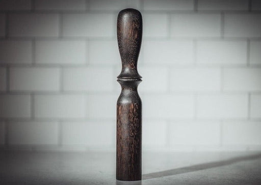 Blanc Creatives cocktail muddler in Noir dark wood finish against white tile background