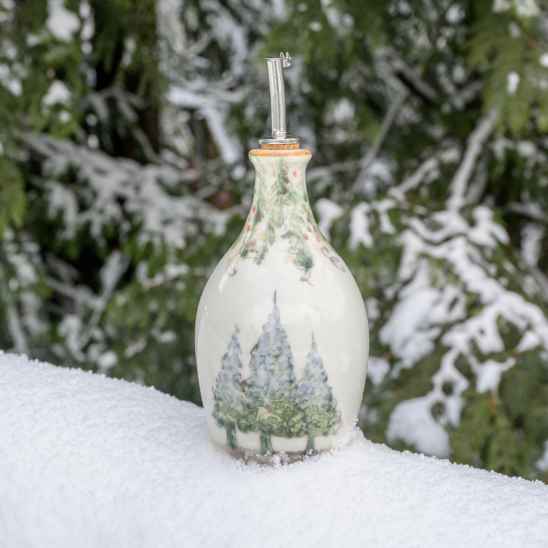 Arte Italica & Crown Linen Designs | Natale Oil Bottle features hand-painted snowy pine trees and garlands, ideal for winter serveware. Perfect for festive displays or gifts.