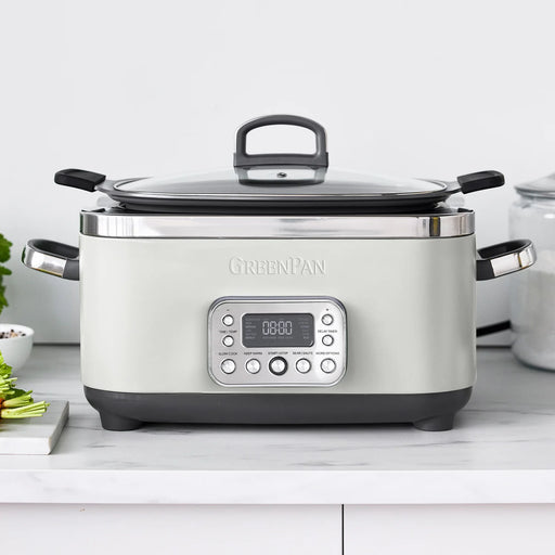 GreenPan | Elite 14-in-1 6-Quart Slow Cooker, Cloud Cream, featuring a digital panel, glass lid, and removable pot, with vegetables and a storage jar nearby.