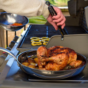 Hestan NanoBond | Cookware, 8.5 Titanium Skillet, with roasted chicken and potatoes, showcasing its high-performance, resilient surface and ergonomic design for superior cooking.