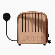 Dualit | 4 Slice Classic Toaster in polished copper, featuring ProHeat® elements, handcrafted in the UK, with defrost and slot selector controls.