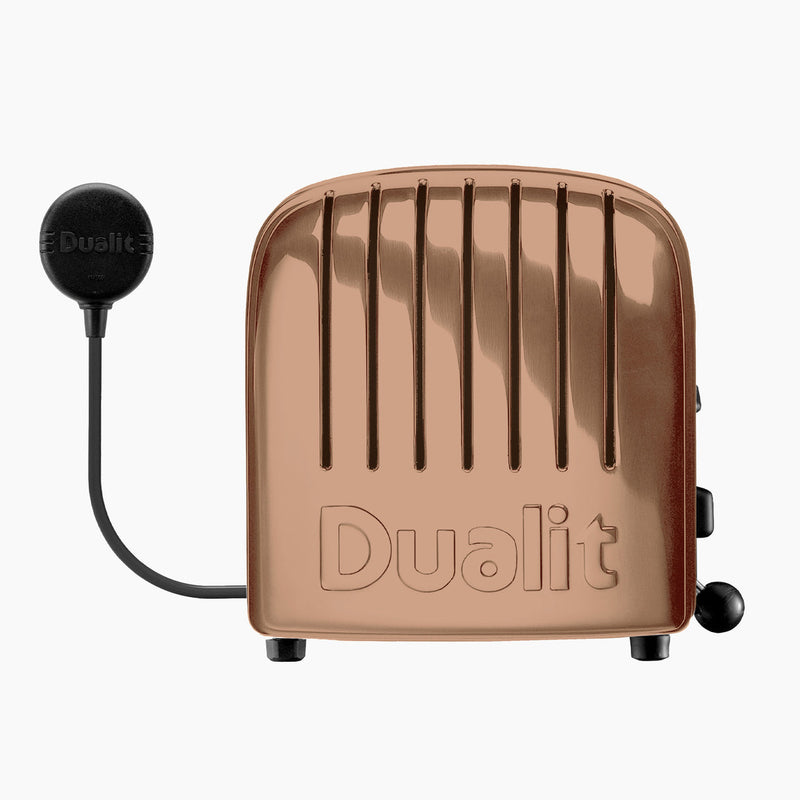 Dualit | 4 Slice Classic Toaster in polished copper, featuring ProHeat® elements, handcrafted in the UK, with defrost and slot selector controls.