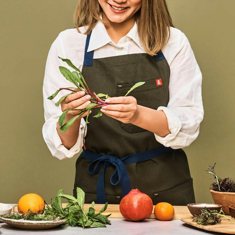 Hedley & Bennett | Essential Aprons - Tahoe Pine: A durable, stain-resistant cotton canvas apron with adjustable neck strap, long waist ties, and multiple pockets for versatile use.