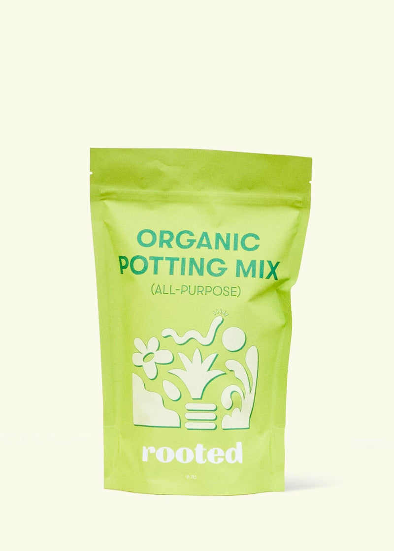 Rooted | Organic Potting Mix - All-Purpose in a green pouch, featuring plant graphics. Contains organic ingredients for optimal nutrient absorption, ideal for tropical houseplants.