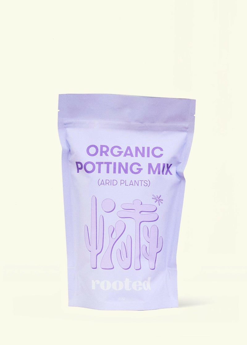 Rooted | Organic Potting Mix - Arid: Stand-up pouch featuring desert plant silhouettes, designed for cacti and succulents with organic compost and nutrient-rich ingredients.