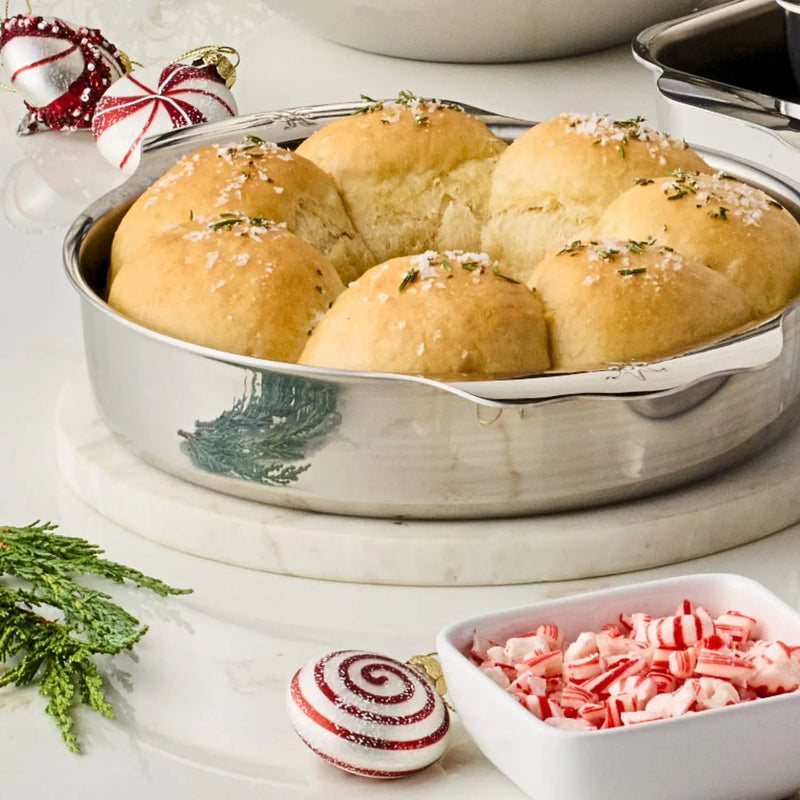 Hestan | OvenBond Round Baker 9 NEW displayed with candy canes and bread, showcasing its versatility for baking and serving in kitchen settings.