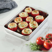 Hestan Provisions OvenBond Bakeware showcases stuffed tomatoes in a stainless-steel pan, reflecting Athens Cooks' commitment to quality kitchen essentials.