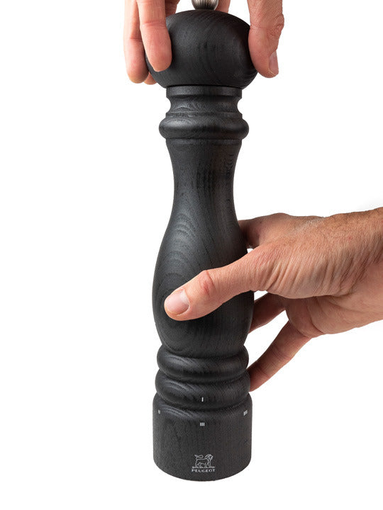 Peugeot | Paris u'Select Wooden Pepper Mill, 12 inches, held for grinding, showcasing its sleek design and adjustable precision grinding system.