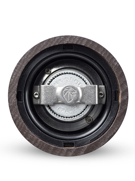 Underside view of the Peugeot | Paris u'Select Wood Pepper Mill Chocolate, 12 inches, showcasing its metal grinding mechanism marked “PEUGEOT FRANCE” within the wooden housing.