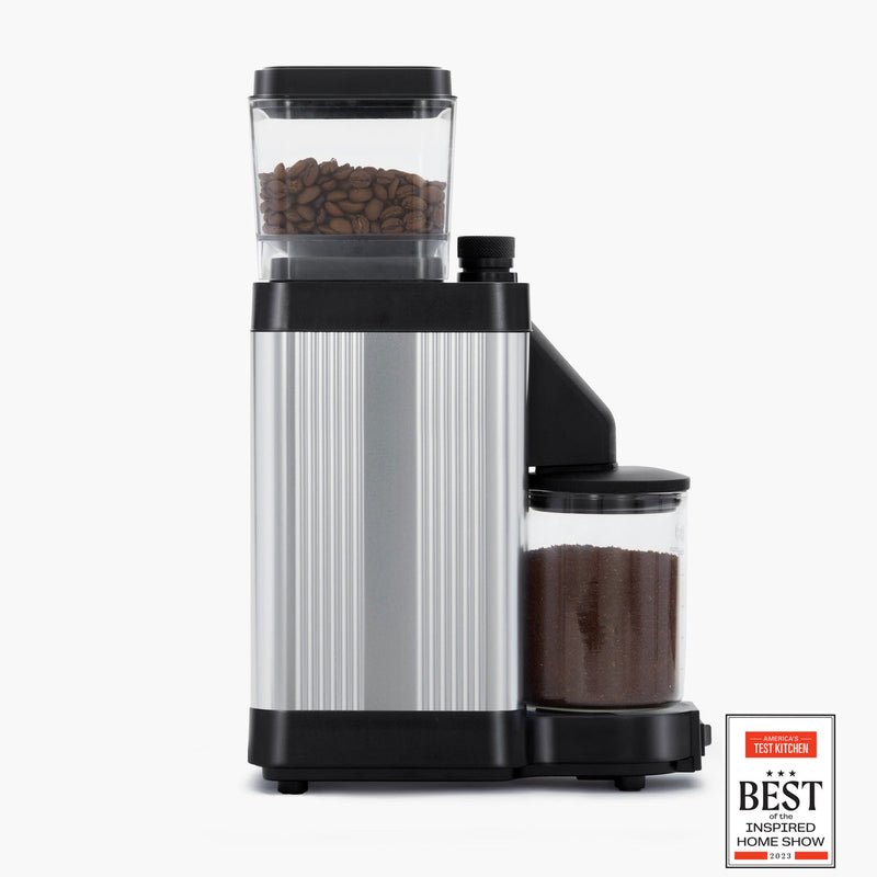 Moccamaster KM5 Burr Grinder with direct-drive motor and stepless knob for precise grind adjustment, displayed in a kitchen setting, exemplifying premium coffee brewing tools.