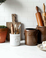 Farmhouse Pottery Agrarian Crocks in 1-2 gallon sizes feature hand-stamped handles and iron-flecked texture, perfect for rustic kitchen decor.