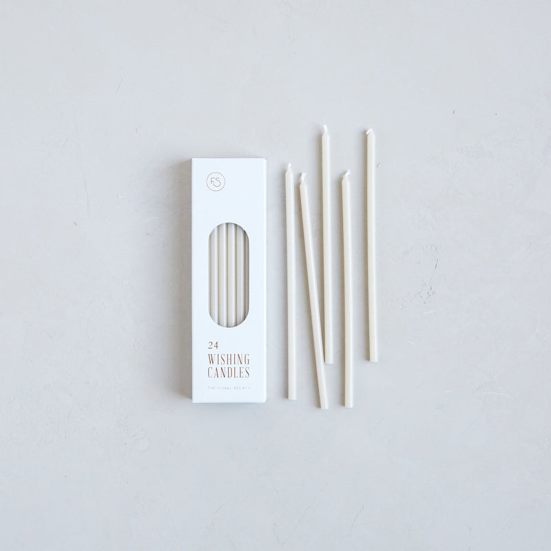 The Floral Society | Wishing Candles, Miel, featuring a box of 24 ivory taper candles, perfect for adding elegance to any occasion or daily ritual.