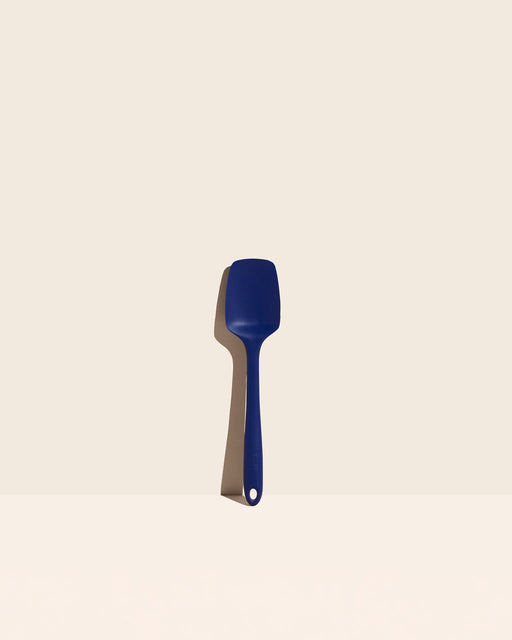 GIR | Ultimate Spoonula - Navy on a white surface, ideal for versatile kitchen tasks like scraping, scooping, and serving, blending spoon and spatula functions.