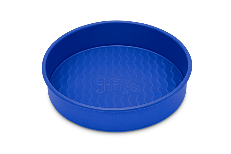 Great Jones | Patty Cake - Broccoli, showcasing its wavy, corrugated stainless-steel design, ideal for effortless baking and easy release of goods.