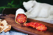 Spotted Trotter Spanish Salchichon Salami, showcasing its marbled interior and spice flecks, ideal for charcuterie at Athens Cooks.