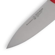 Messermeister | Petite Messer Red Chef's Knife, 5 inches, showcasing the engraved blade details and craftsmanship in a close-up against a white background.