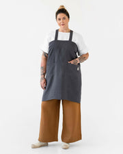 MagicLinen Pinafore Cross-Back Linen Apron in Dusty Blue, L-XL, featuring criss-cross straps and side pockets, ideal for cooking or gardening.