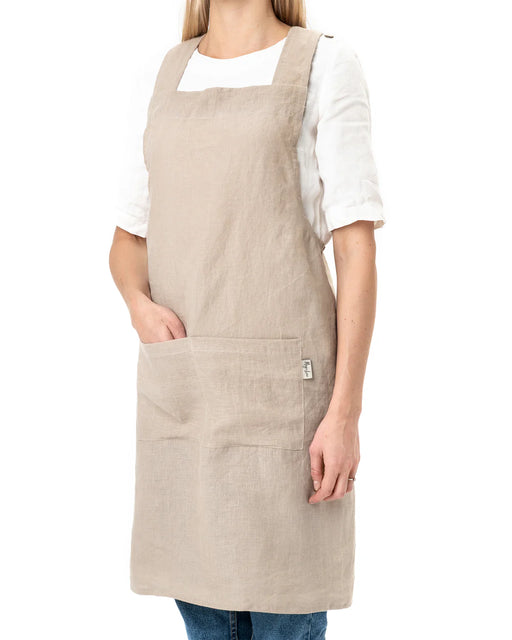 MagicLinen Pinafore Cross-Back Linen Apron in L-XL, featuring a stylish design with criss-cross straps and side pockets, perfect for cooking or gardening.