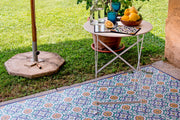 Etú HOME | Positano B Italian Vinyl Rug displayed on a table with fruit, highlighting its Italian-inspired design, perfect for kitchen or outdoor use.