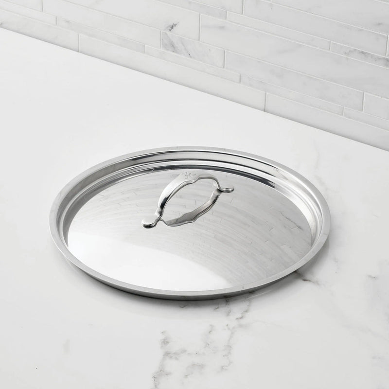 Hestan Provisions | Stainless Steel Lids Large, 12.5 shown on a marble countertop, featuring a raised handle for secure grip and durable tri-ply stainless-steel construction.