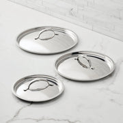 Hestan Provisions | Stainless Steel Lids Large, 12.5, displayed on a marble surface, showcasing ergonomic handles and durable tri-ply construction for optimal cooking performance.