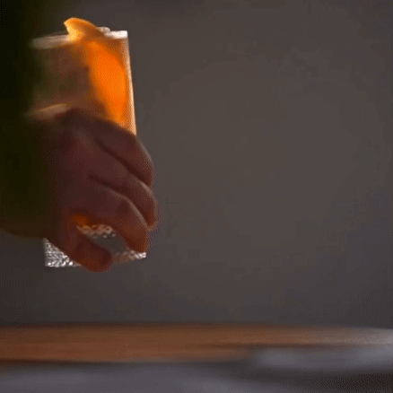 Richard Brendon | Diamond Highball glass held in a hand, showcasing its intricate diamond pattern design, perfect for enhancing any cocktail experience.