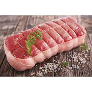 Cooking Twine with Wooden Holder next to a piece of red meat garnished with parsley, showcasing its utility in preparing meats.