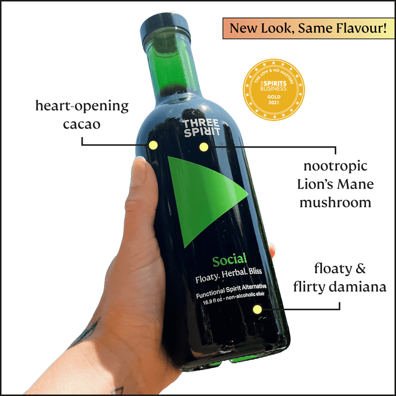 Three Spirit | Botanical Social Elixers' Social Elixer: A hand holds a dark-green bottle highlighting cacao, Lion’s Mane, and damiana; award-winning non-alcoholic spirit.