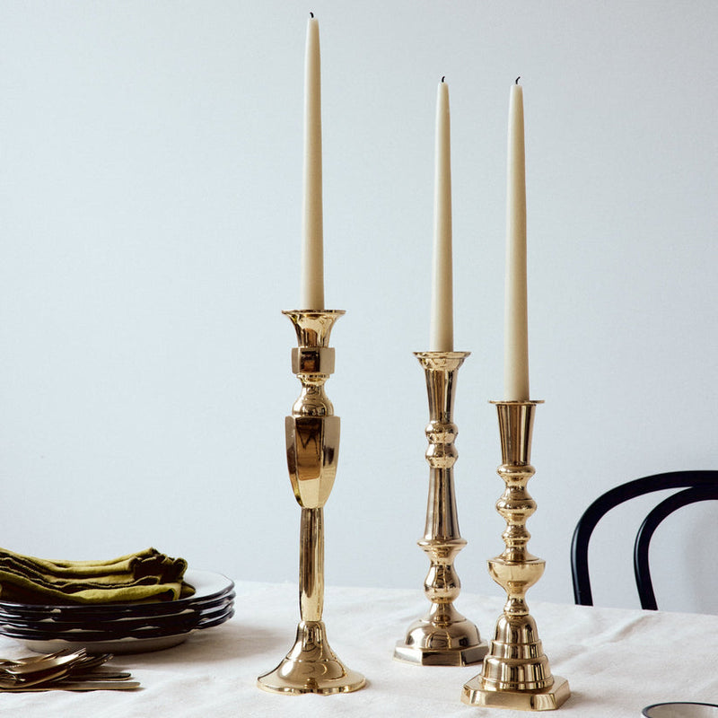 Sir|Madam | Georgian Candlestick No. 4, Brass, elegantly styled with white taper candles alongside tableware, exemplifying classic charm and versatility for sophisticated dining settings.