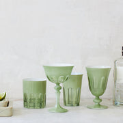 Sir|Madam Rialto Pale Sage glassware lineup — coupe, tumbler, highball, and wine — on a marble surface with lime and a gin bottle
