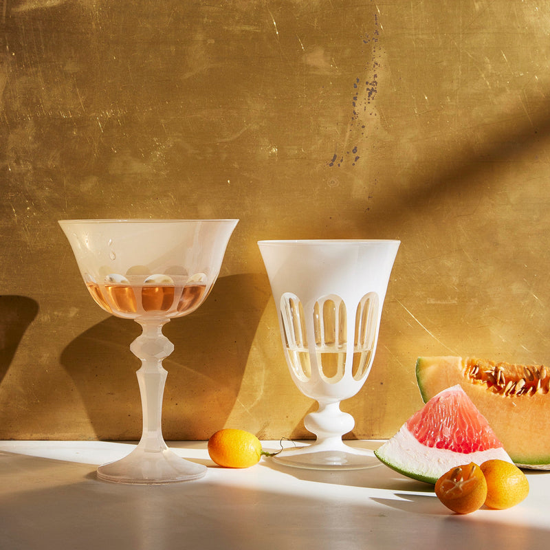 Sir|Madam Rialto Opal coupe and tulip glass styled on a sunlit table with melon and kumquats
