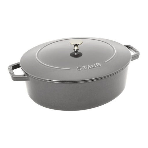 Staub | Wide Oval Dutch Oven - Graphite Grey, featuring a brass knob lid, ideal for braising and baking, offering 20% more cooking surface for versatile culinary use.