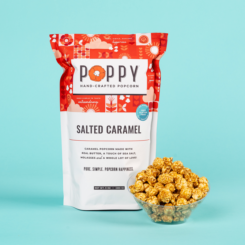 Poppy | Handcrafted Popcorns - Salted Caramel, packaged in a bag, includes a bowl of caramel popcorn, emphasizing its artisanal, gluten-free, and Non-GMO qualities.