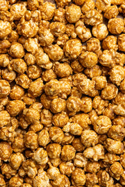 Poppy | Handcrafted Popcorns - Salted Caramel: A close-up of a pile of caramel popcorn, showcasing its rich texture and handcrafted allure.