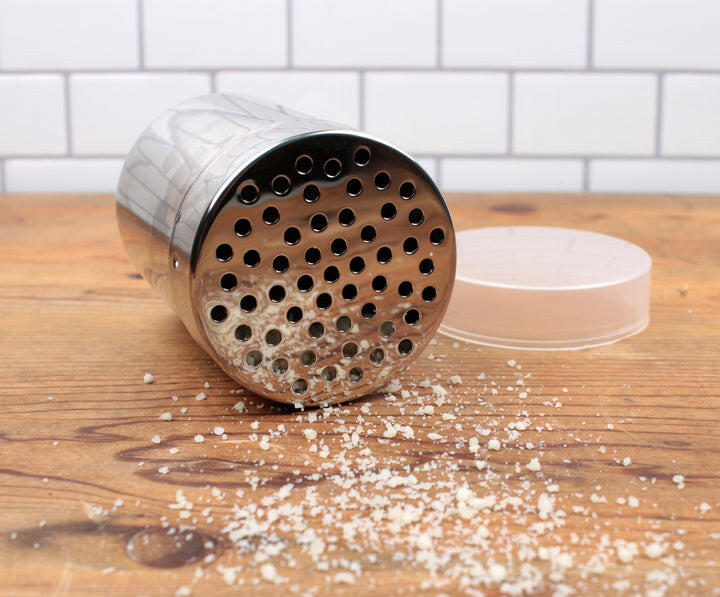 Shaker - Fine Mesh on table, featuring a compact design with a perforated lid, ideal for dispensing spices or powdered sugar. Perfect for small kitchens.
