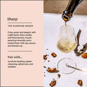 Three Spirit | Blurred Vines Sharp wine being poured into a glass, surrounded by nutshells, highlighting its focus-enhancing attributes with notes of gooseberry and lime.