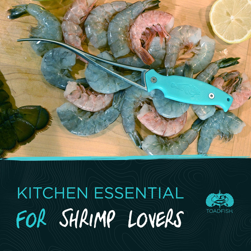 Toadfish Shrimp Cleaner on a wooden surface with shrimp, showcasing its design for peeling, deveining, and butterflying shrimp efficiently.