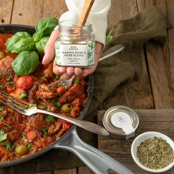 Bona Furtuna | Sicilian Seasonings - Mama Rose's Herb Blend, showcased in a hand, ideal for enhancing a variety of dishes with traditional Italian flavors.
