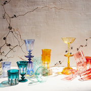 Sir|Madam Rialto Old Fashion set of 2 in light red, artfully arranged among twisting branches, showcasing handcrafted glassware inspired by Venetian arches.