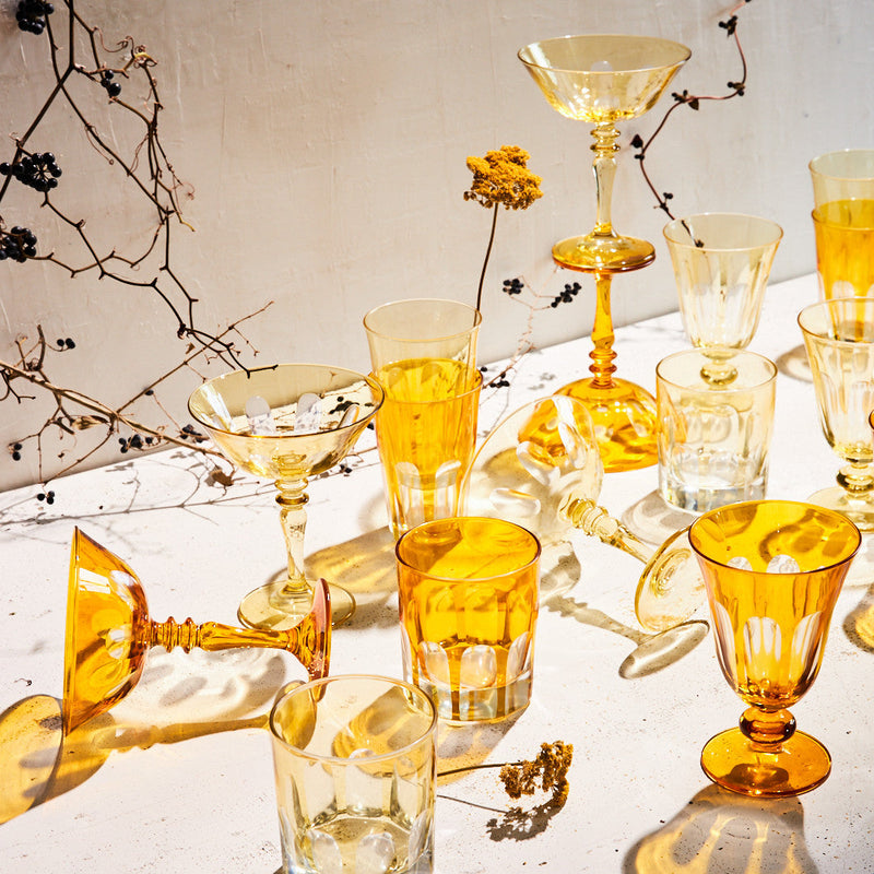 Sir|Madam Rialto Ginger glassware styled together on a white table with dried flowers and warm sunlight