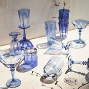 Sir|Madam Rialto Moon Glow coupe styled with the blue-family glassware collection in natural light