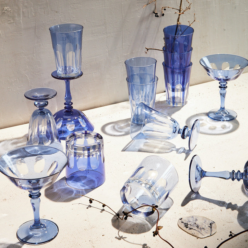 Sir|Madam Rialto Moon Glow coupe styled with the blue-family glassware collection in natural light