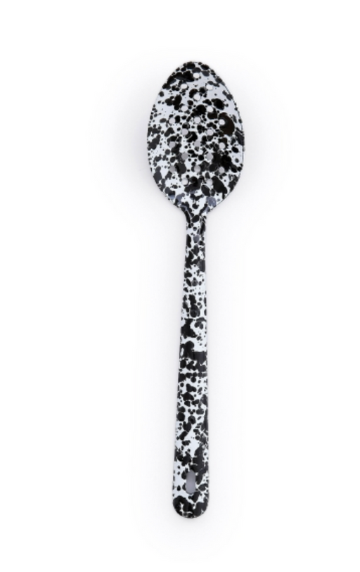 Crow Canyon Home Splatter Enamelware Large Slotted Spoon in black splatter pattern, showcasing its durable, stylish design ideal for both indoor and outdoor dining.